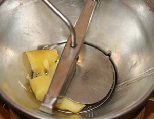 sending potatoes through a food mill